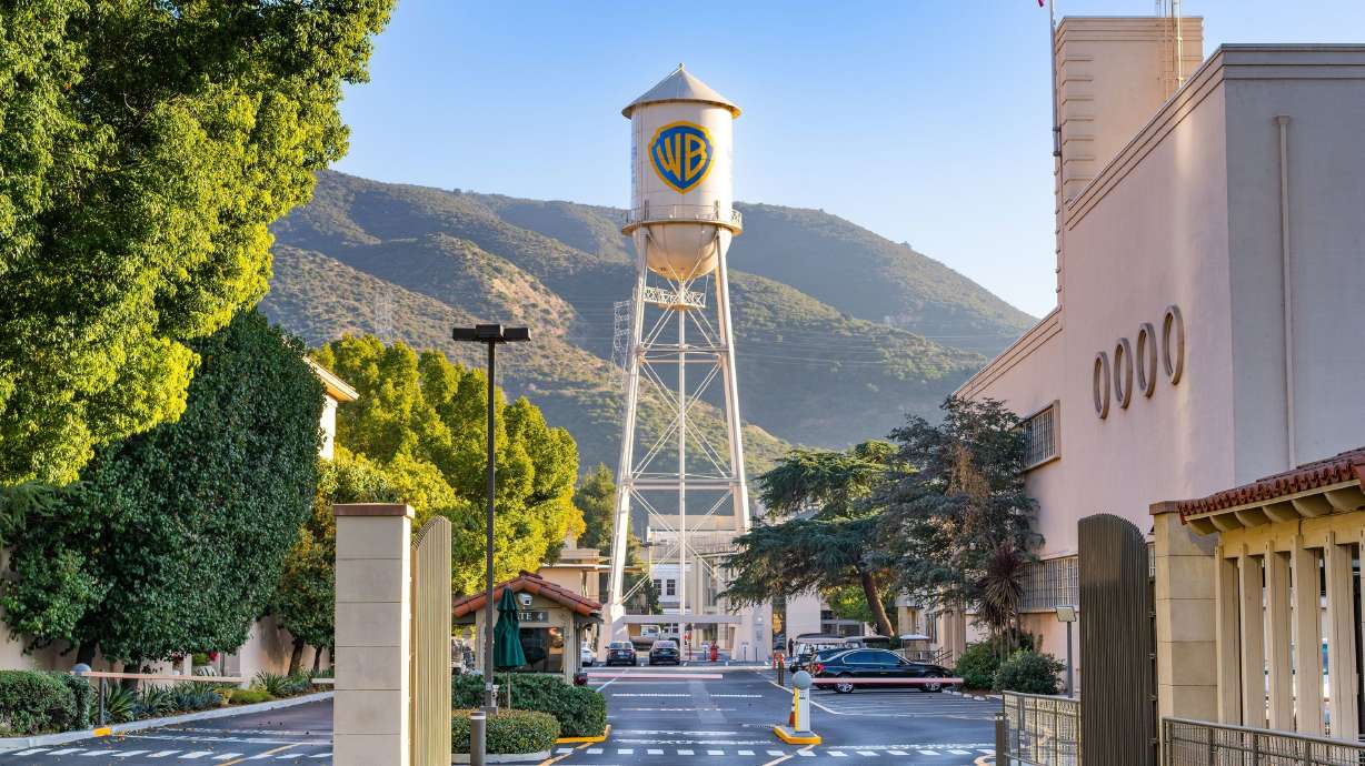 Warner Bros. studio water tower rising above the lot with hills behind it